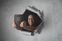 peeking holding a Bible 