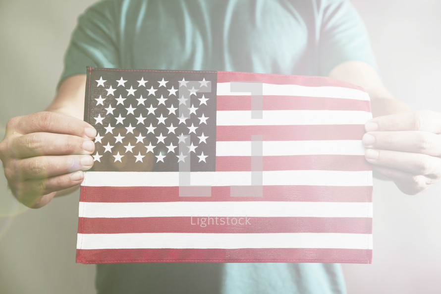 hands holding an American Flag