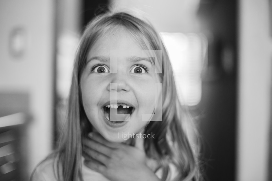 Little girl with a surprised look on her face.