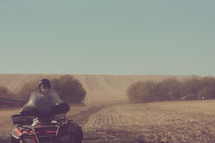 young teen on an ATV at the farm
