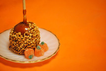 Taffy apple with peanuts and gumdrop candy pumpkins.
