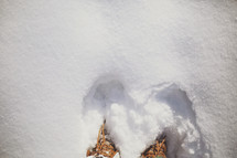 looking down at my boots in the deep snow
