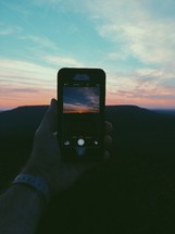 taking a picture of a sunset with a cellphone 