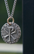 Pewter medallion on chain with chi rho emblem.