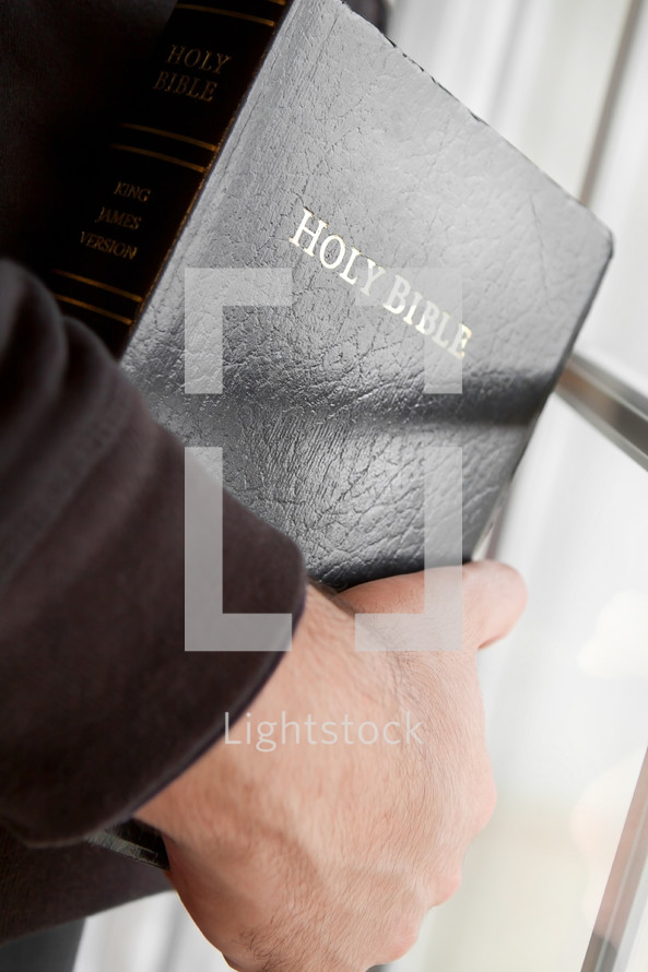 man holding a Holy Bible