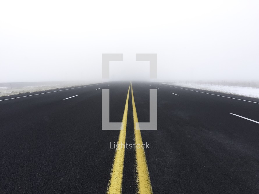 center lines on a foggy road 