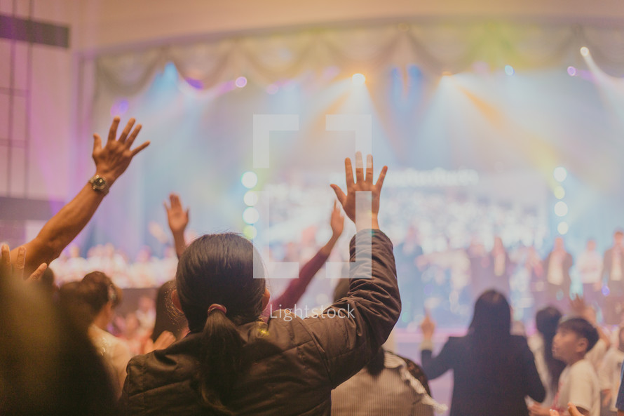 raised hands and group worship 