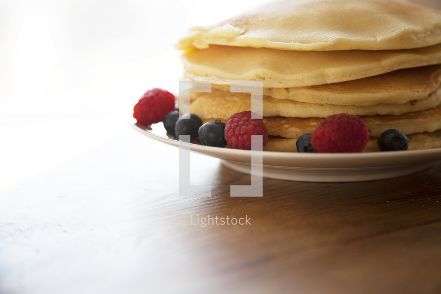 stack of pancakes with berries 