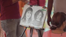 Drawing of two little girls on an easel in Vizag Visakhapatnam, India.