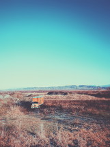 abandoned moving truck in a field 