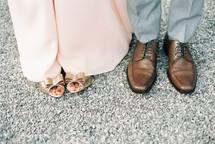 feet of a couple standing together 