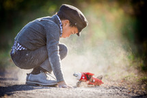 a boy playing with a toy airplane 