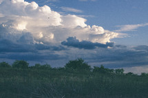 Cloud formations over a meadow.
