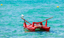 View of an italian lifeguard boat (salvataggio) in beautiful clear tropical sea water from Gallipoli, Italy.