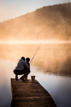 father and son fishing on a pier 