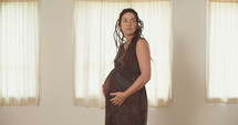 Pregnant woman holding her belly.