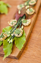 Appetizer Arrangement on wooden block and green leaves