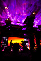 Worship concert service lighting pink yellow orange hands raised church service
