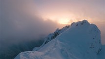 Panorama Mystic Winter Mountain peak in top of snowy alps mountains at golden sunrise
