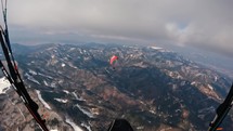 Paragliding flight over winter forest mountains nature, freedom adrenaline adventure
