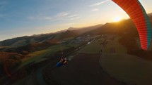 Swing on paragliding wing at golden sunset 
