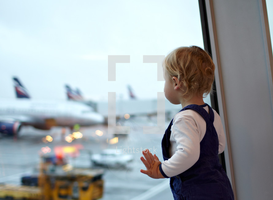 Kid near the window in the airport