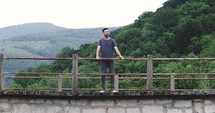 Man thinking on a high bridge in the nature