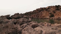 Woman on a rocky shore