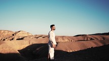 a man walking alone in the desert 