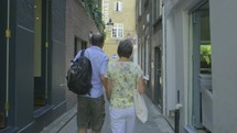 senior caucasian couple walking holding hands 