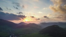Colorful sunset over green nature. Aerial view Time lapse
