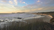 Calm evening in ninety mile beach in New Zealand ocean coast wild nature in summer sunset evening
