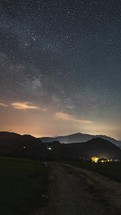 Vertical panorama of Starry night sky with Milky Way Galaxy stars over countryside landscape Astronomy Timelapse
