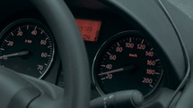 Close-up shot of dashboard and speedometer while someone is driving.