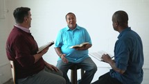 men Reading Bibles and discussing scripture 