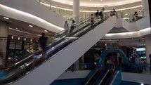 Timelapse of people on escalators in trade centre