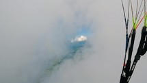 Flying in the clouds on paragliding adrenaline adventure
