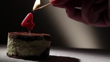 Candle four in tiramisu cake