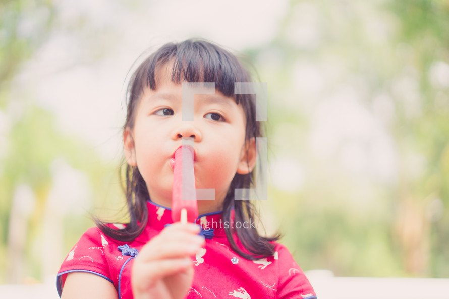 girl eating a popsicle 