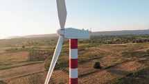 Wind Turbine with red and white tower 