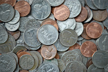A heap of assorted US coins of many denominations. closeup