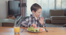 Boy refusing to eat healthy food