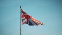 Union Jack British Flag blowing in the wind, United Kingdom, national emblem, flagpole