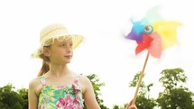 Girl holding a coloured windmill