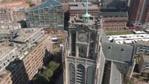 Circling footage of the St. Laurenskerk the Great Church, a building from the middle-ages, and it's grounds amongst the modern-day city of Rotterdam, Netherlands.