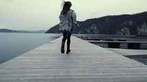 a woman running on a dock 