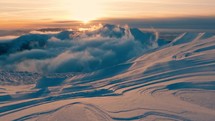 Sunrise over winter mountains landscape with beautiful snowdrift structure, outdoor adventrue background
