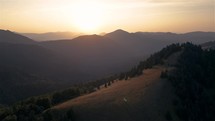 Aerial view of Carpathian mountains in autumn nature landscape at golden sunrise
