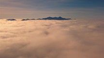Calm fly high above clouds in sunny morning alpine mountains nature at sunrise freedom heaven adventure

