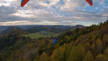 Peaceful paragliding flight above autumn forest country, freedom flying adventrue
